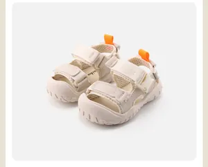 Close-up of beige toddler outdoor sports sandals featuring soft non-slip soles and orange pull tabs