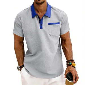 Detail shot of a grey waffle knit polo shirt featuring a vibrant blue contrast collar