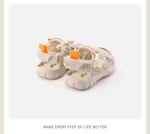 Rear view of cream baby summer sandals with soft sole and bright orange heel pull tabs