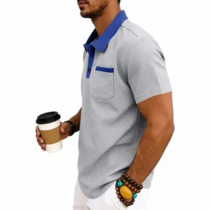Side view of men's waffle knit polo shirt with blue contrast collar and pocket detail