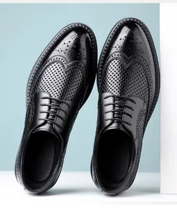 Close-up detail of black leather brogue shoes featuring breathable hollow-out wingtip pattern