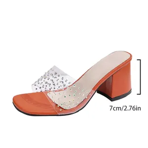 Detail of orange block heel sandals with 7cm heel height and clear rhinestone strap