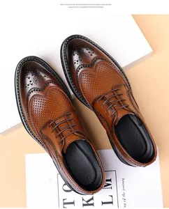 Detailed view of brown brogue shoes with perforated design and embossed leather texture.
