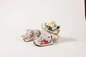 Primo piano di scarpe in rete per bambini nei colori rosa, giallo e rosso su base neutra
