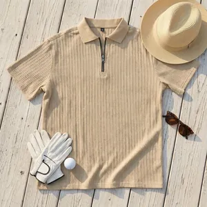 Textured knit men's polo shirt with zipper collar and golf accessories layout