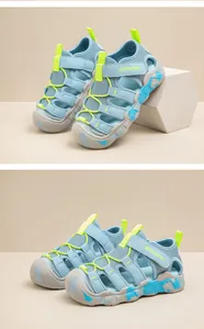 Detailed view of blue children's outdoor water sandals with green accents and non-slip soles.