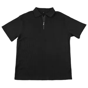 Close-up of black men's knit polo shirt with cable texture and quarter-zip neck