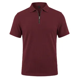 Close-up of burgundy men's polo shirt featuring a textured knit and half-zip collar