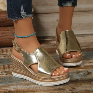Women's metallic gold peep-toe wedge sandals with thick platform and ankle strap.
