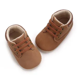 Close-up top view of brown soft-sole baby walking shoes for infant boys ages zero to one