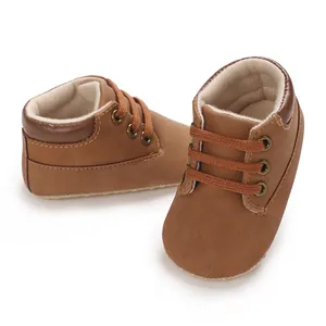 Detailed macro view of soft brown suede-like infant baby walking shoes with laces