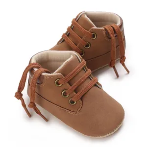 Detailed close-up view of brown PU leather high-top baby walker shoes with lace-up design