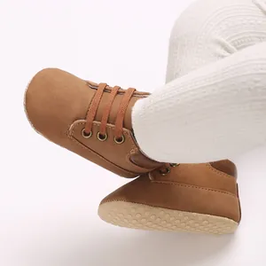 Detailed shot of brown PU leather high-top baby walking shoes with soft non-slip soles