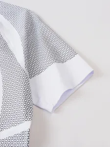 Close-up detail of men's athletic shirt sleeve with grey hexagonal honeycomb pattern