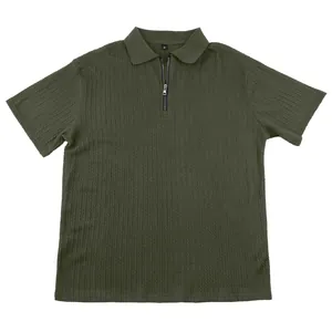 Detailed close-up of men's dark green knit polo shirt with zipper and texture