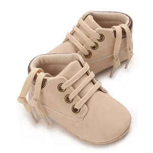 Close-up of beige PU leather infant pre-walker shoes with soft soles and laces