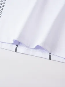 Close-up detail of white compression t-shirt hem showing high-quality stitching and fabric