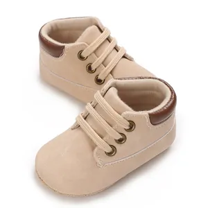 Soft beige baby walking shoes featuring brown trim and comfortable lace-up details for infants