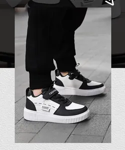 Side view detail of kids' black and white casual sneakers with velcro strap