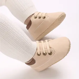 Detail view of beige soft-sole baby walking shoes with lace-up high-top design