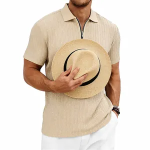 Close-up detail of men's beige knit polo shirt featuring unique texture and zip collar