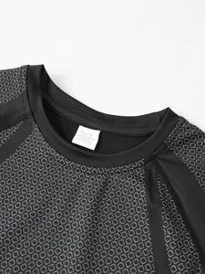 Close-up detail of black men's compression t-shirt neckline and grey hexagonal textured fabric