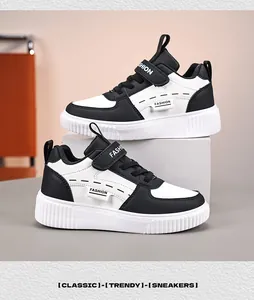 Detailed macro view of classic black and white sneakers for children with velcro straps