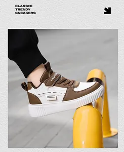 Close-up view of children's classic brown and white casual board shoes in street setting.