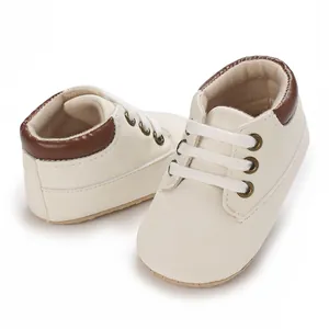 Detailed macro view of cream and brown baby walking shoes with soft flexible soles