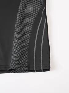 Macro view of men's compression t-shirt with grey honeycomb pattern and stripes.