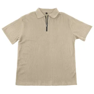Detailed macro view of a beige men's knitted polo shirt with zip placket and cable texture.