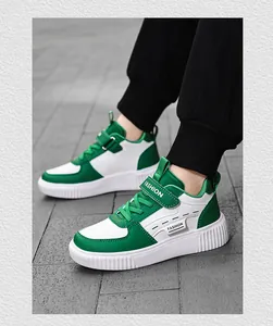 Detailed side view of children's green and white casual sneakers with Fashion strap design