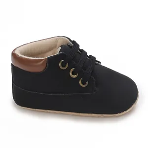 Classic black high-top infant walking shoes with soft soles and brown trim details
