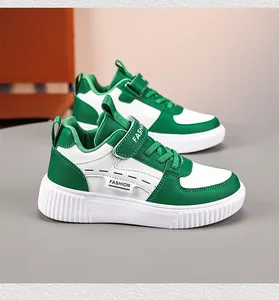 Close-up detail of green and white children's casual sneakers with velcro straps