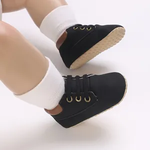 Detailed view of black PU leather baby walker shoes with soft non-slip soles for infants