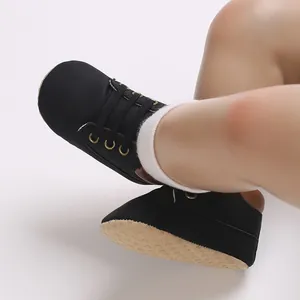 Close-up detail of black soft sole baby high-top lace-up shoes with anti-slip texture sole