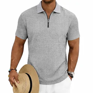 Detail showing the textured knit and zipper of this grey men's short-sleeve polo shirt