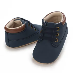 Detailed macro view of navy blue baby boy walker shoes with soft suede and brown trim