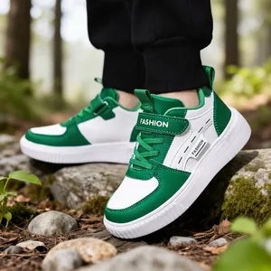 Kids' green and white casual sneakers featuring a stylish hook-and-loop strap design.