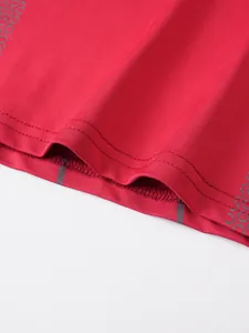 Detailed view of the durable double-stitched hem on red men's athletic compression t-shirt