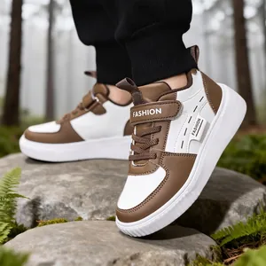 Classic children's brown and white skate shoes for boys and girls in outdoor setting