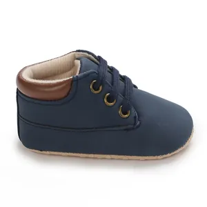Detail view of navy blue high-top soft sole baby walking shoe with lace-up design