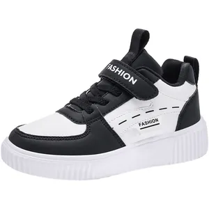 Classic black and white children's casual sneakers with velcro straps and warm lining