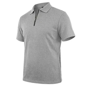 Close-up of men's grey textured knit polo shirt with stylish zipper collar detail.