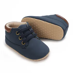 Detail view of navy blue soft-soled high-top infant walker shoes with non-slip dots