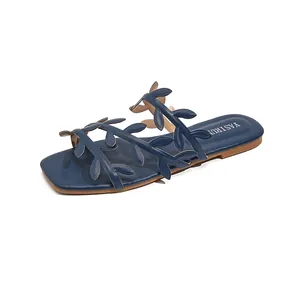 Elegant navy blue women's flat sandals with decorative leaf pattern for summer beachwear