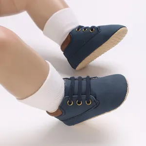 Close-up shot of navy blue PU baby pre-walker shoes with soft anti-slip rubber soles