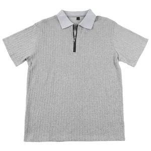 Close-up detail of grey knitted men's polo shirt featuring front zipper and textured fabric