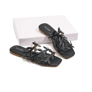 Elegant black flat sandals for women featuring unique leaf-shaped straps for summer beach wear