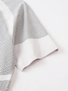 Close-up detail of white and grey geometric patterned sleeve on men's sports T-shirt